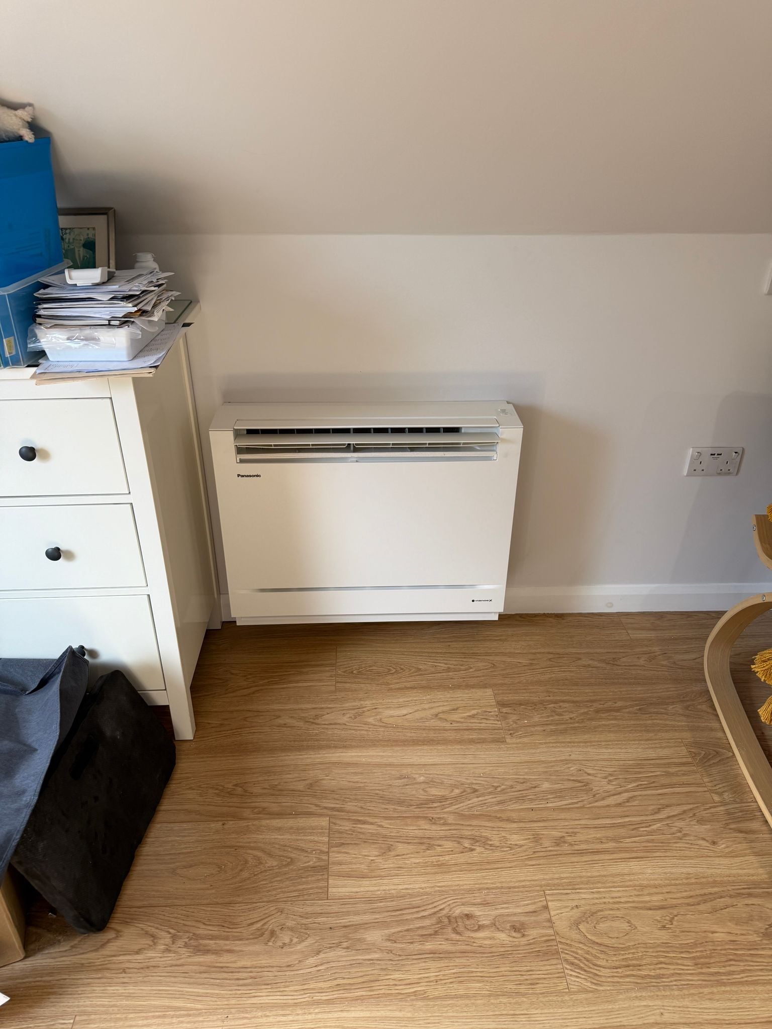 Panasonic floor standing console heat pump unit on a wooden floor