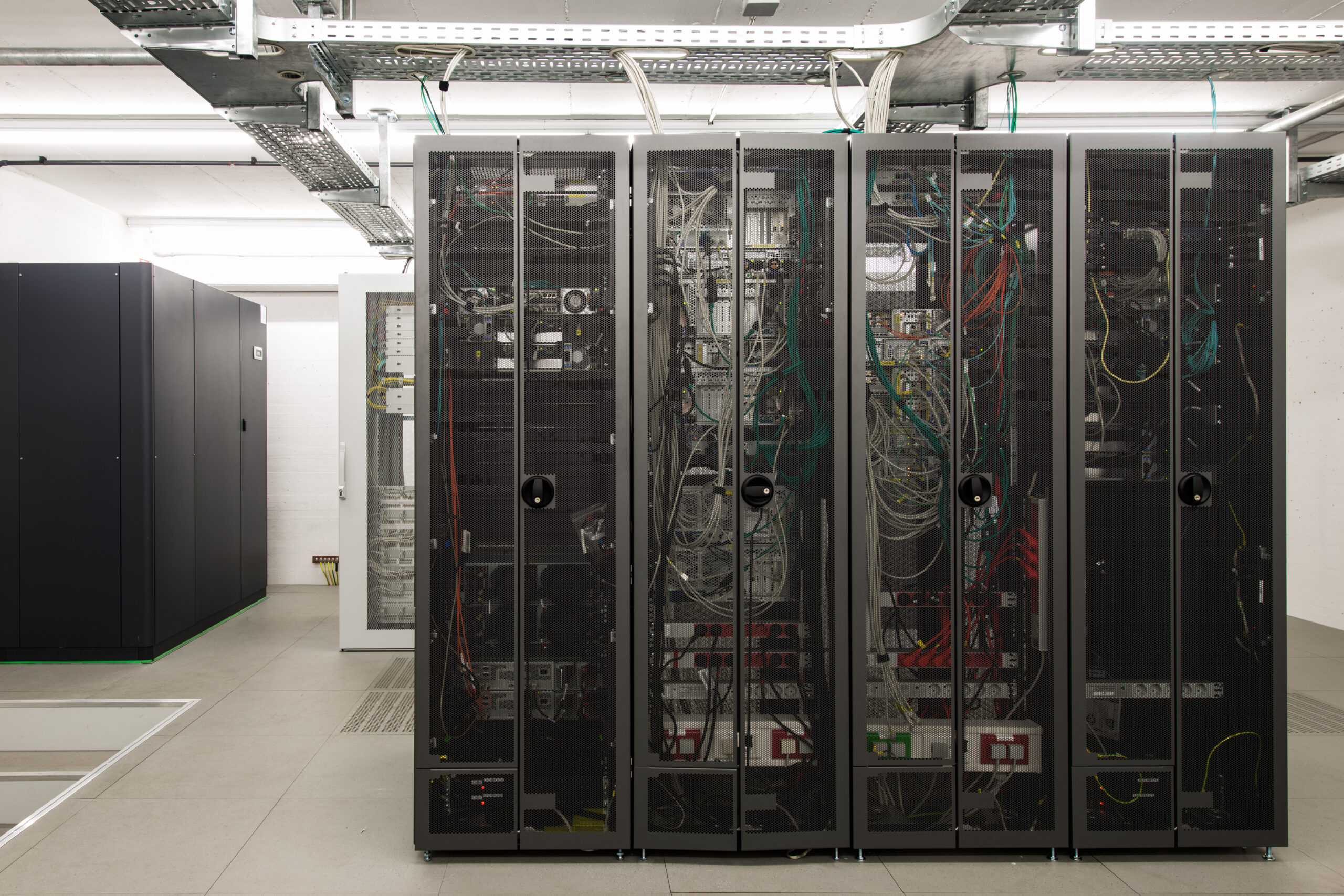 Black server racks in a temperature-controlled server room