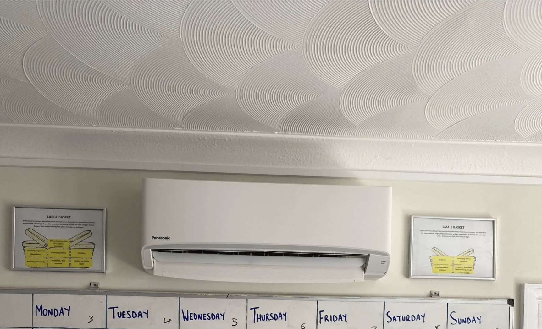 Wall-mounted Panasonic split air conditioning unit installed in a communal activity room