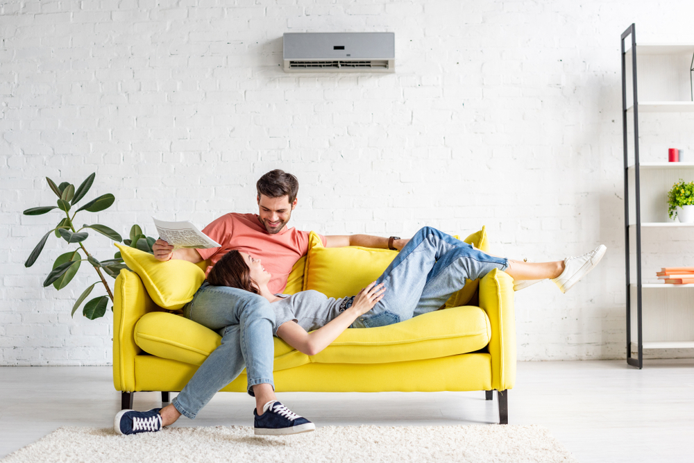 happy couple relaxing after finding out how much to install air conditioning